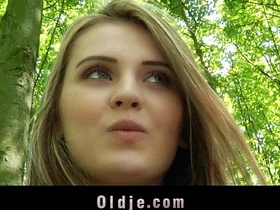 A mature man and a young woman engage in various sexual acts in the woods