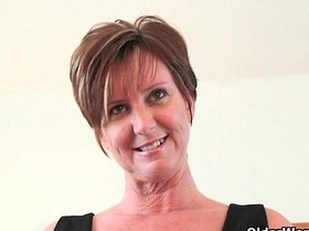 Elegant mature woman Joy indulges in fingering and anal play with a dildo